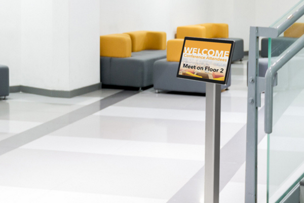 Tablet stand in office building hallway.